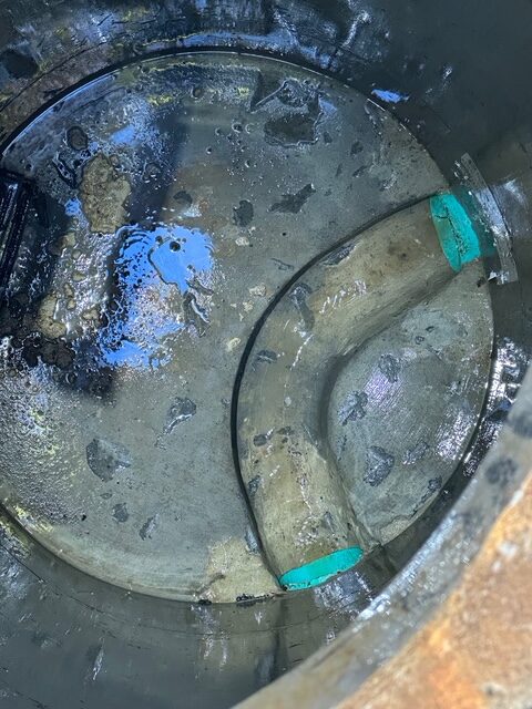 Wet concrete surface with blue paint splatters.