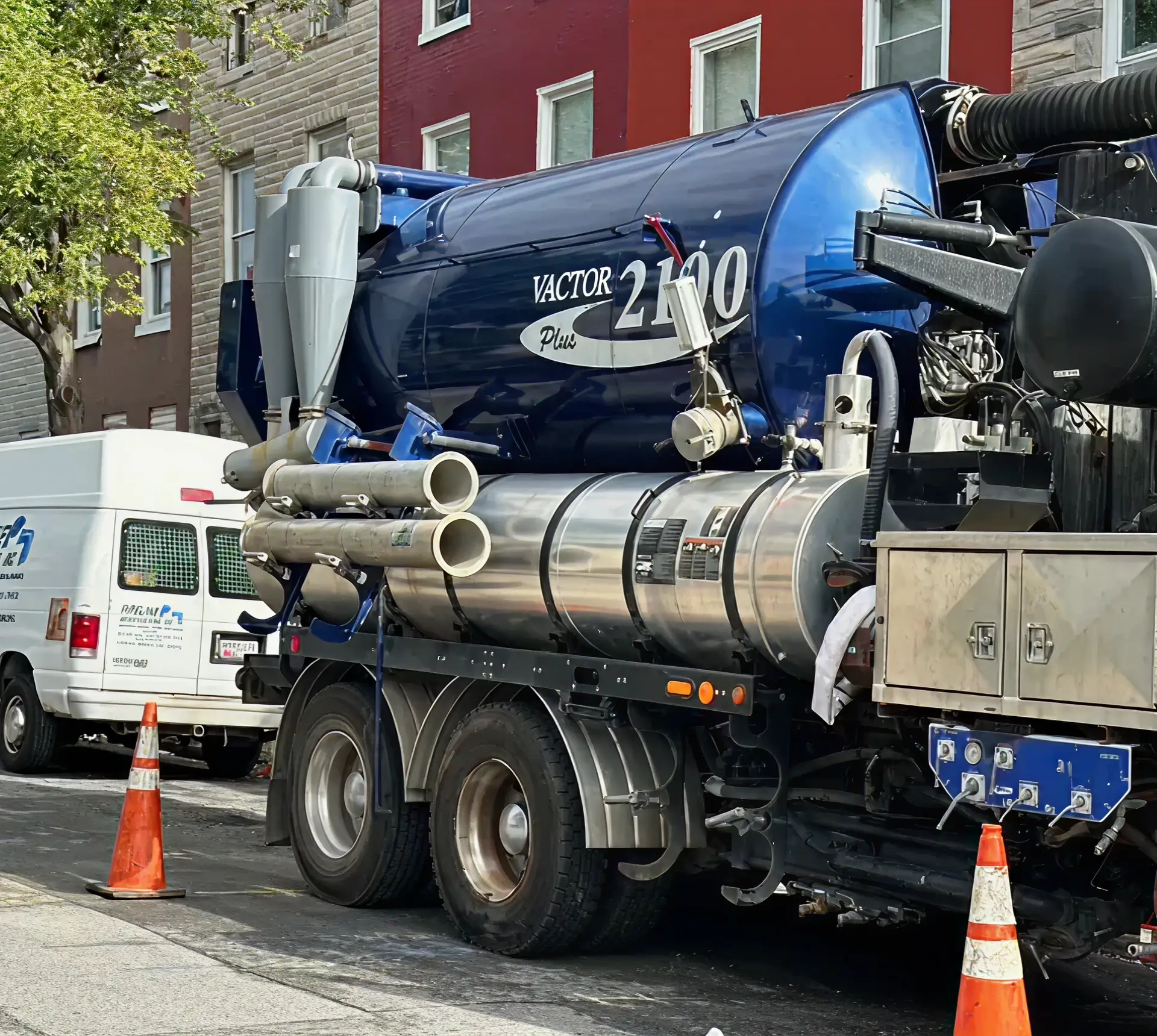 Vacuum truck parked on urban street.