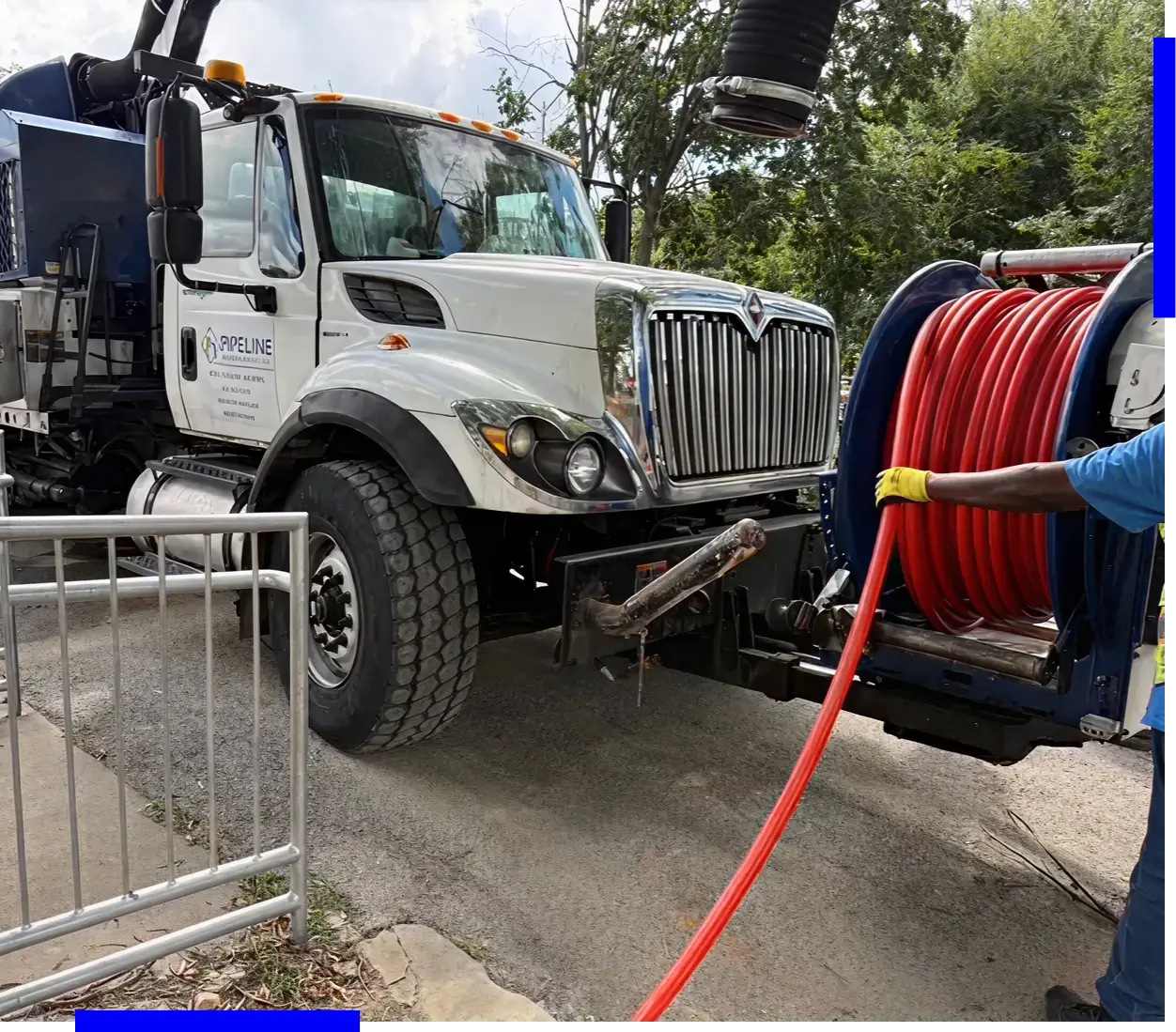 Truck with hose and worker operating.